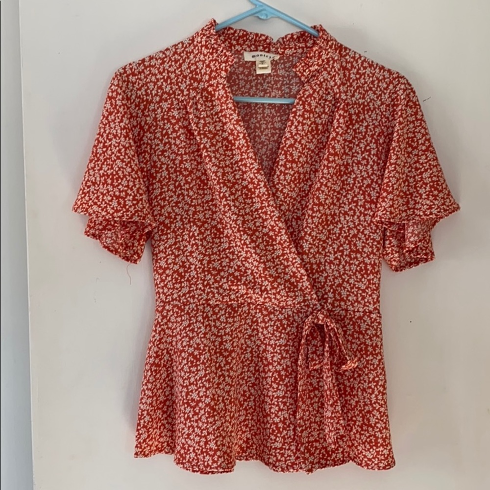 Feminine wrap style blouse with bow tie.